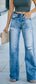 A pair of distressed straight leg jeans with high waist, no stretch, and a top worn by a model with a neutral facial expression, standing on the sidewalk.